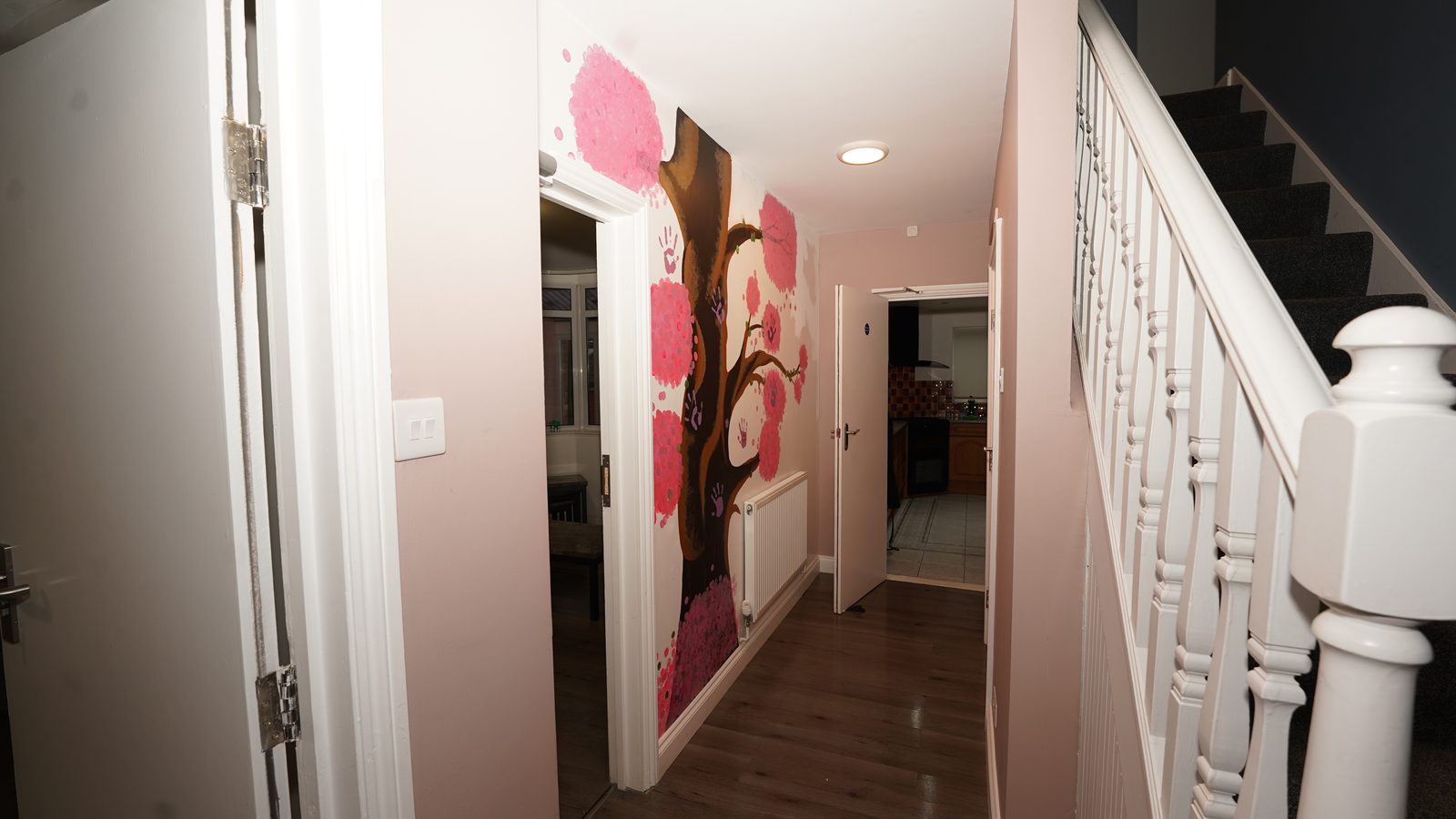 Hallway with personal artwork at Lisette House